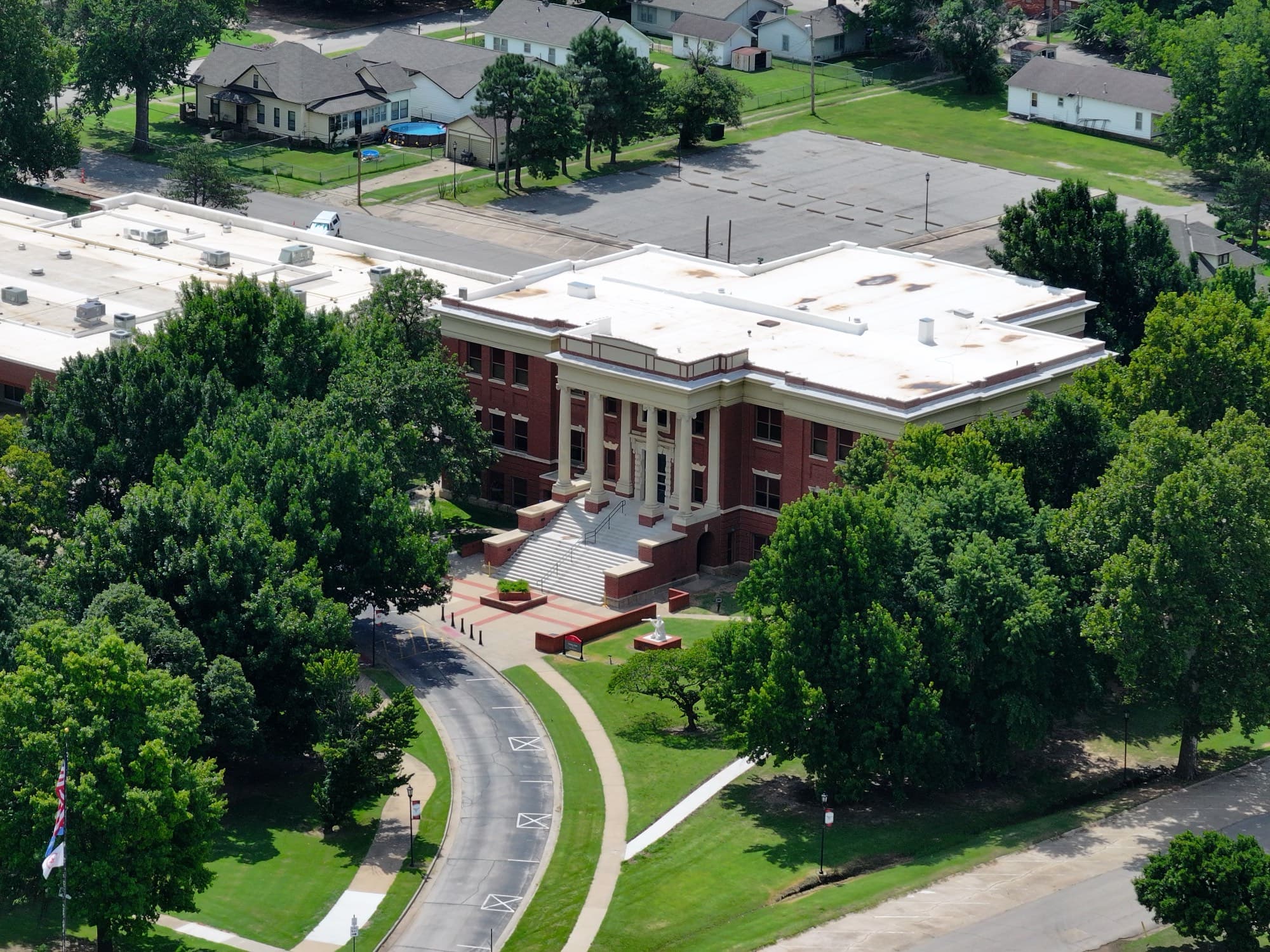 Aerial view of a historic red brick academic building on the Tonkawa campus